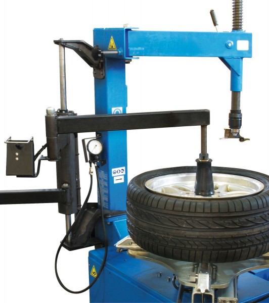 Pushing down in the center will assist a stiff sidewall tire to be clamped from the outside